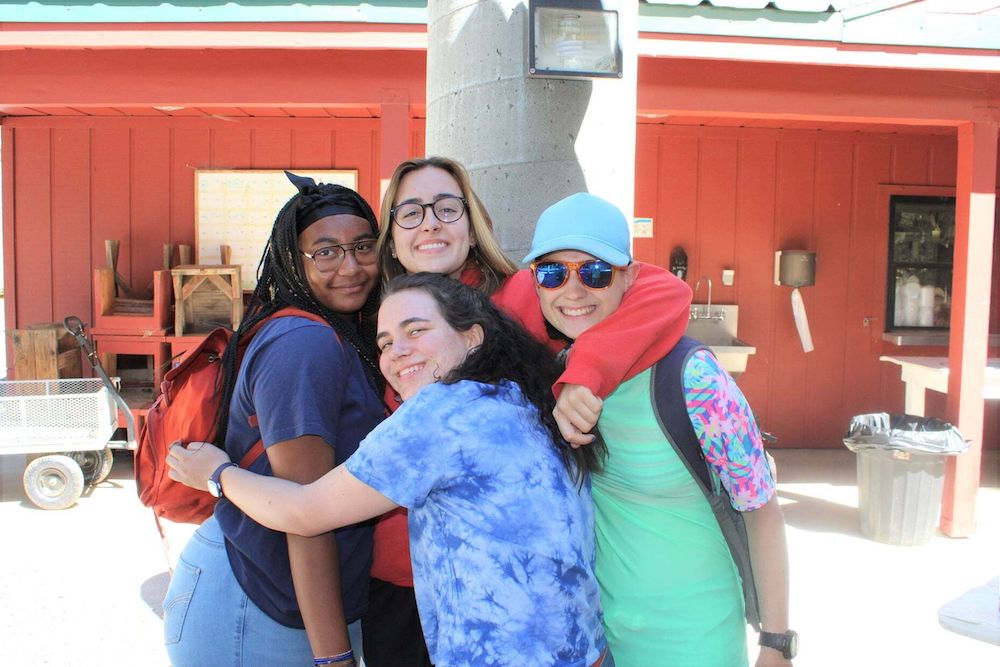 Group of girls hugging at camp